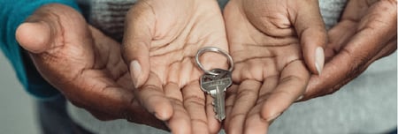New homeowner holding house key
