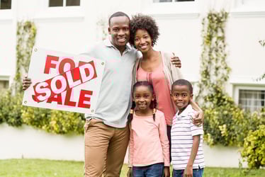 family near sold house sign 
