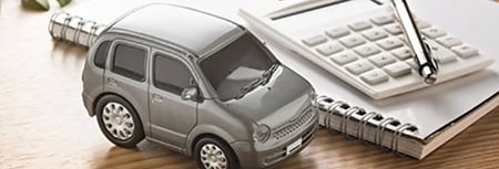 Toy Car next to Calculator 