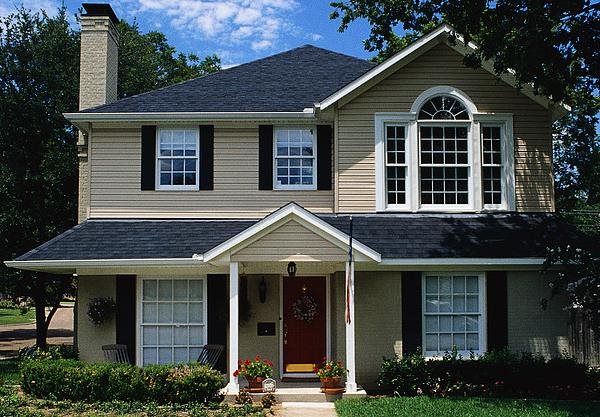 Light brown house with shutters.