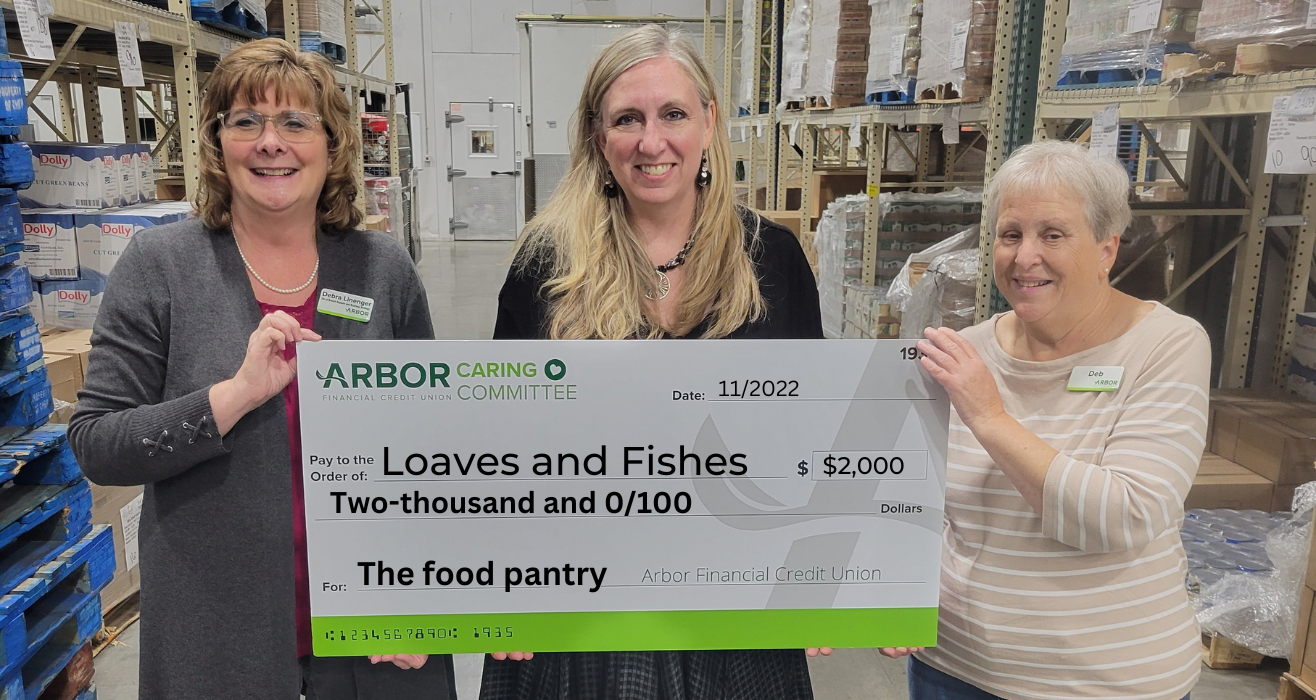 Arbor employees presenting a donation check.