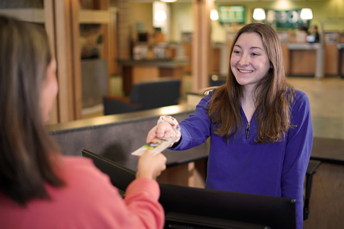 Teller helping Member with Deposit