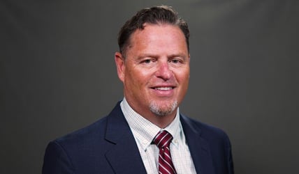 Professional headshot of John 