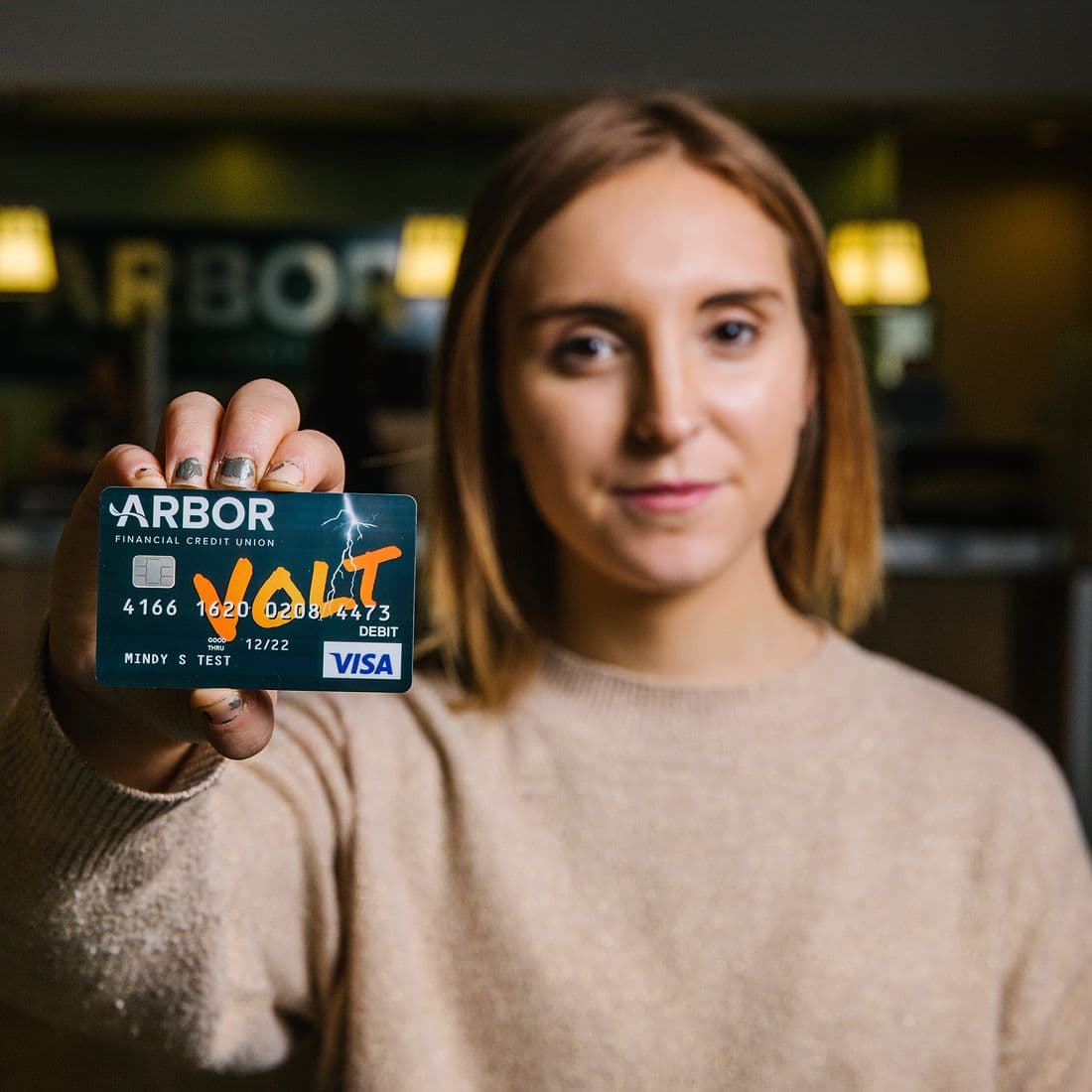 College student holding Volt Visa Card