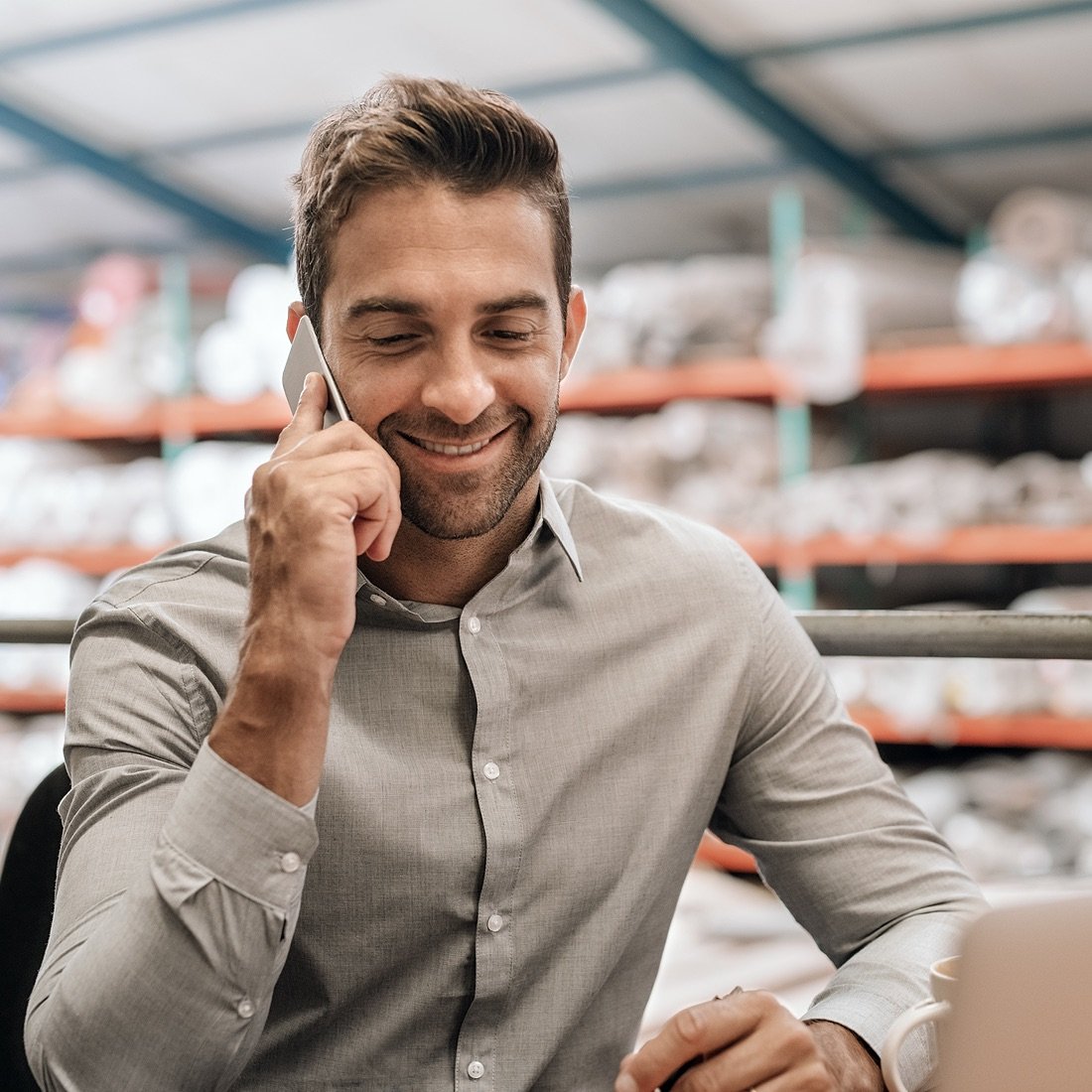 Business owner on phone in warehouse.