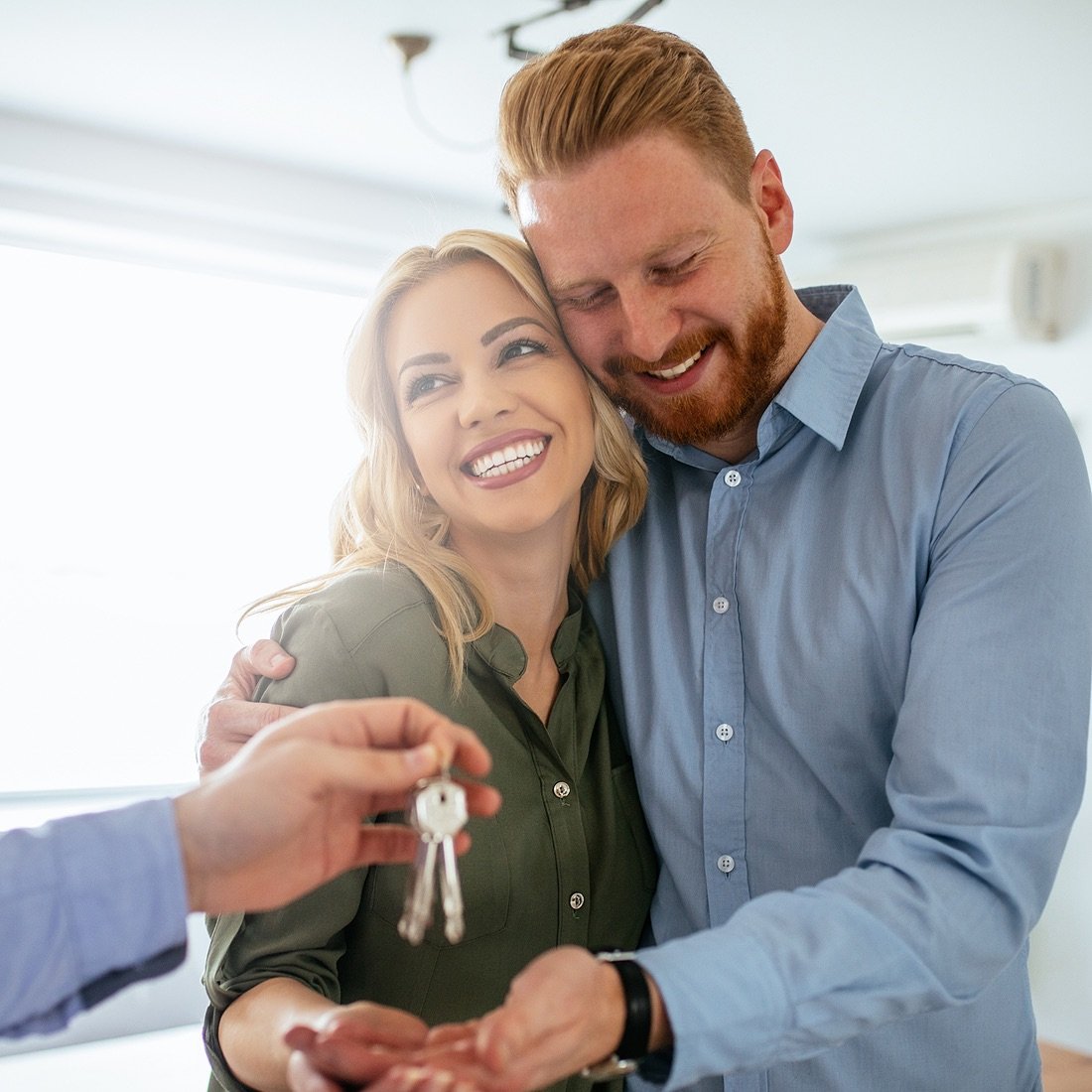 couple getting keys to house