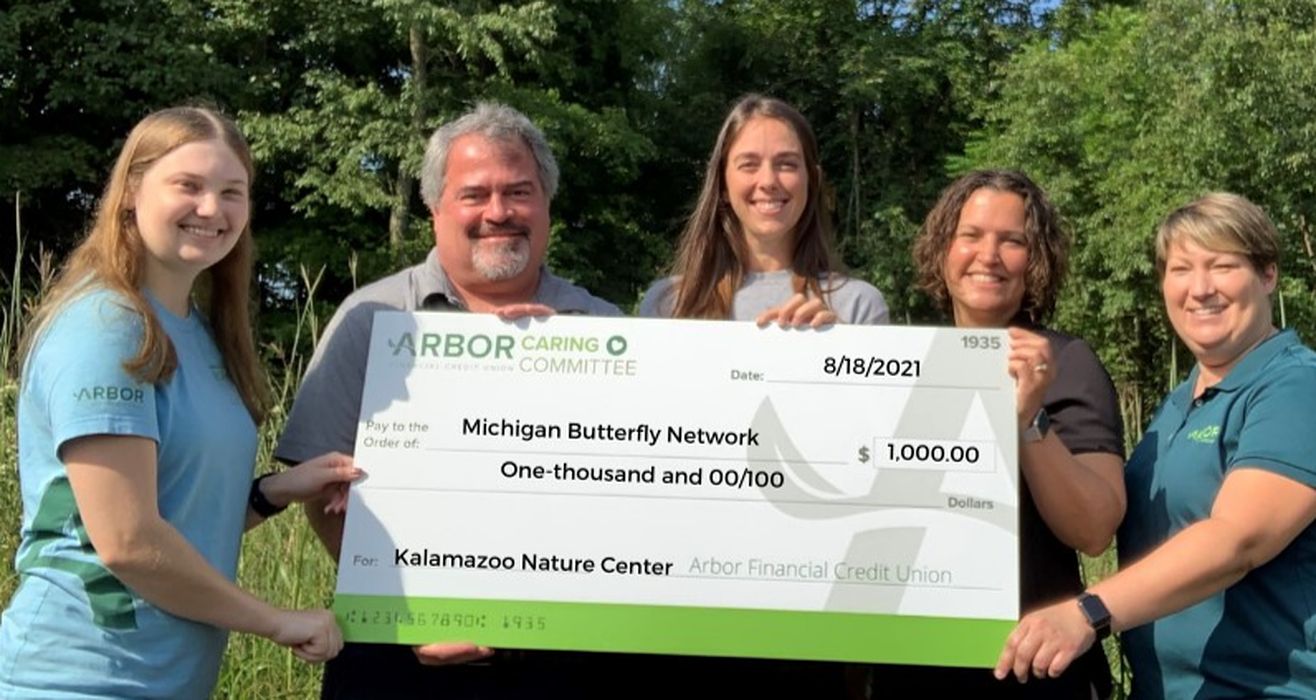 Arbor employees presenting a donation check.