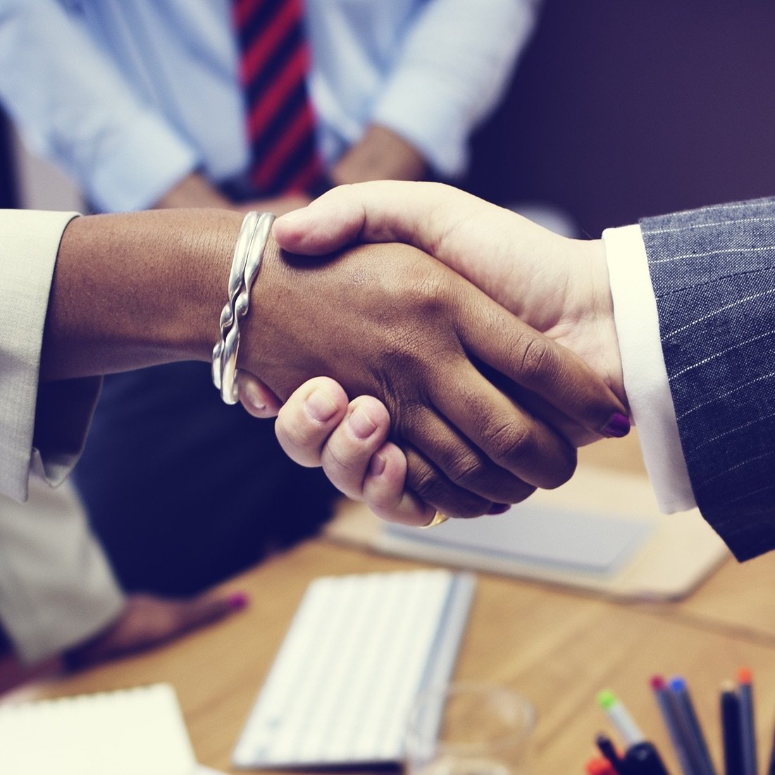 Handshake over table.