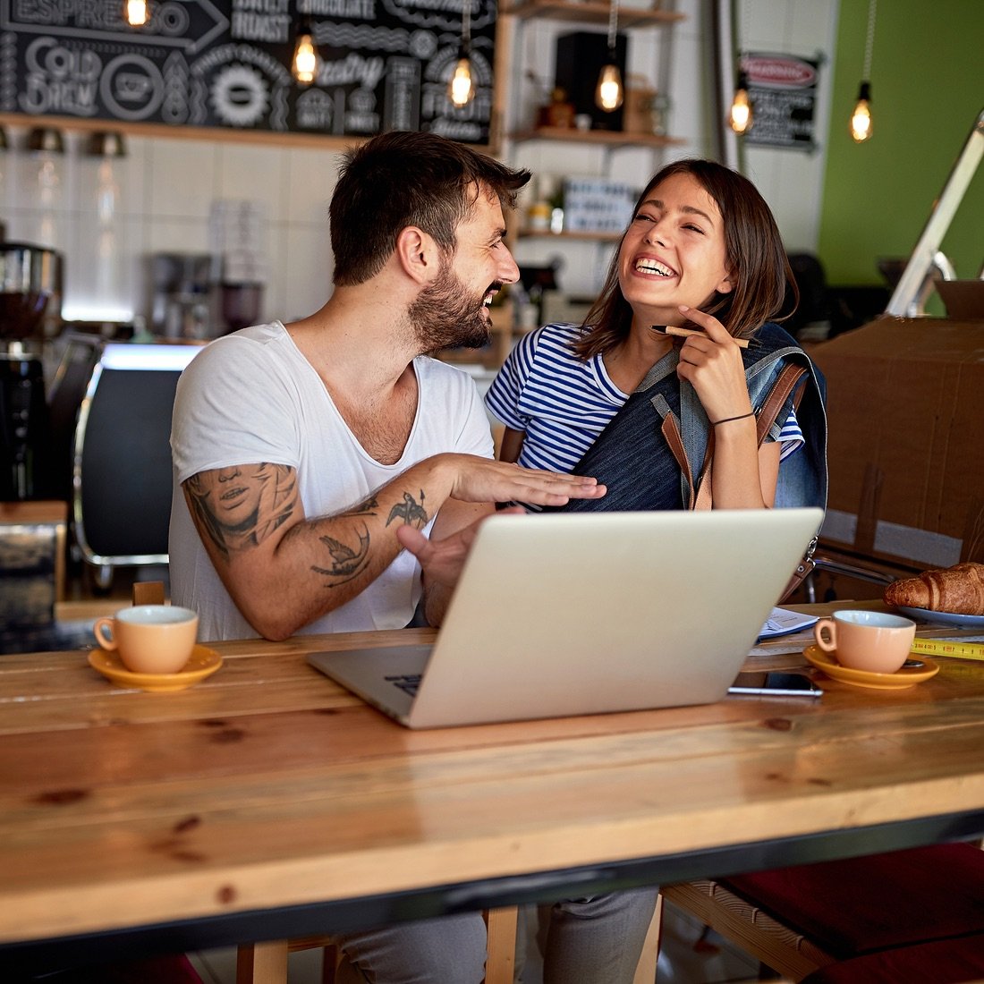 Coffee shop owners using a computer.