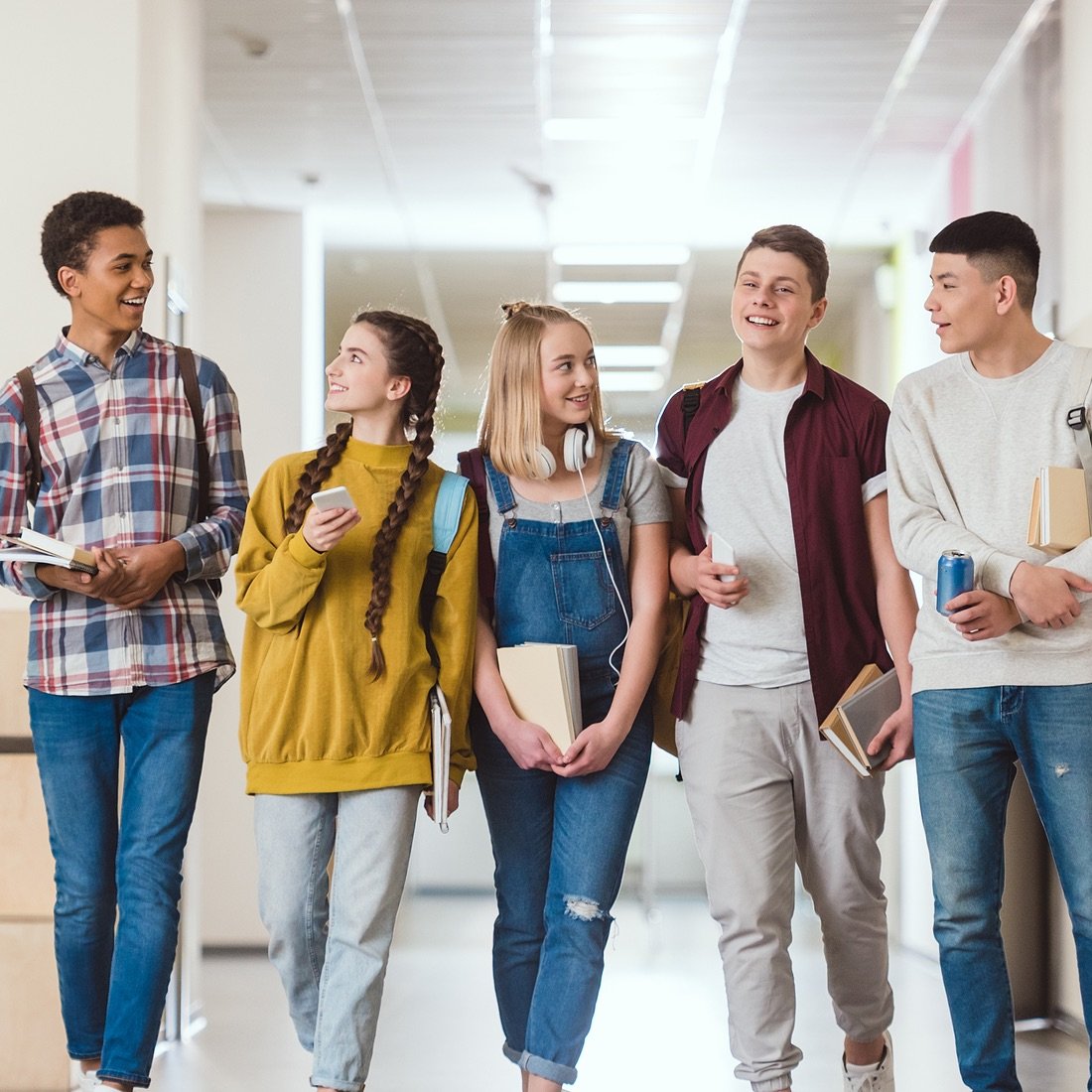 Group of high school students in school hallway.