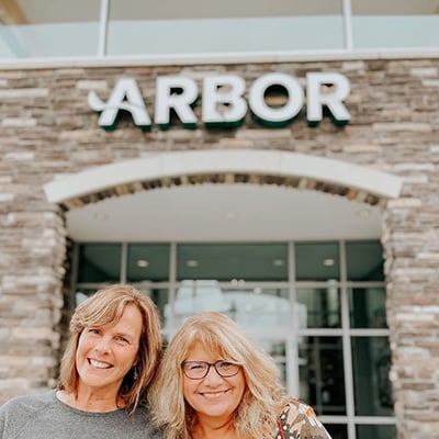Jane and Arbor Financial member smiling outside of an Arbor location.
