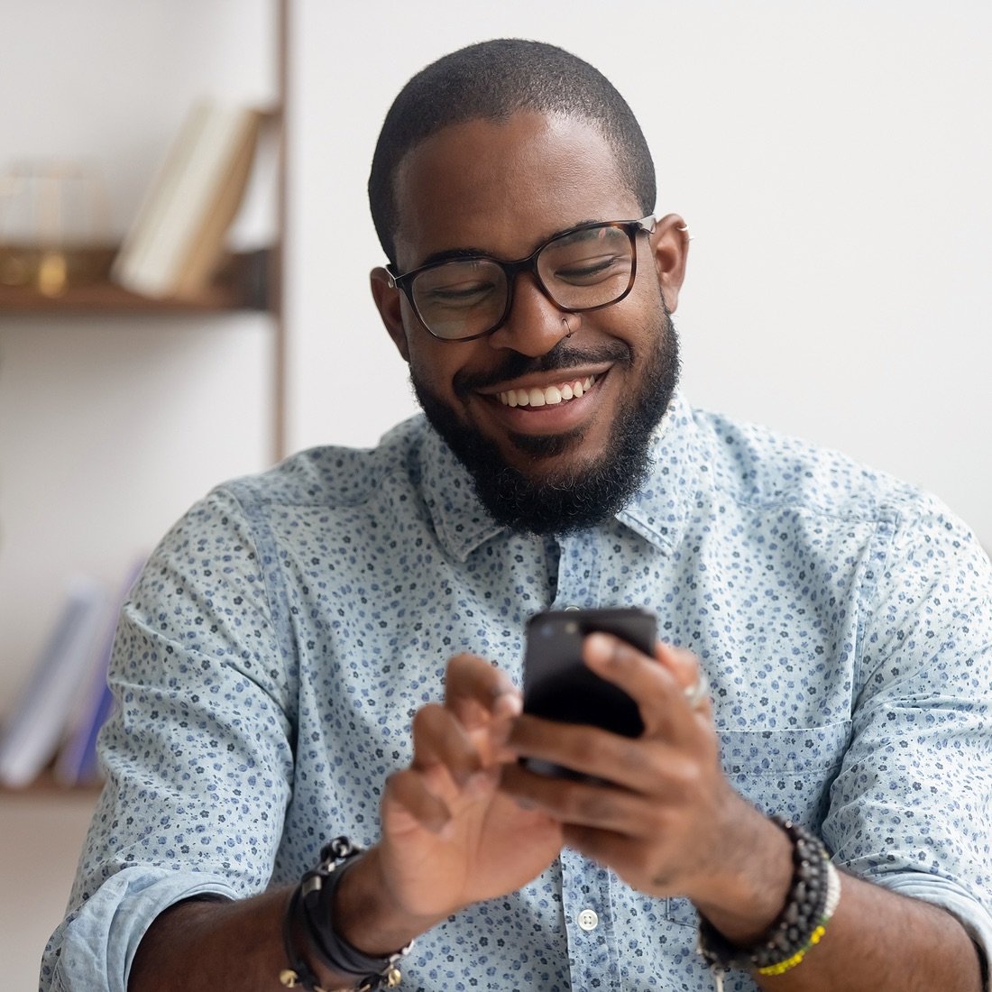 man looking at phone happy