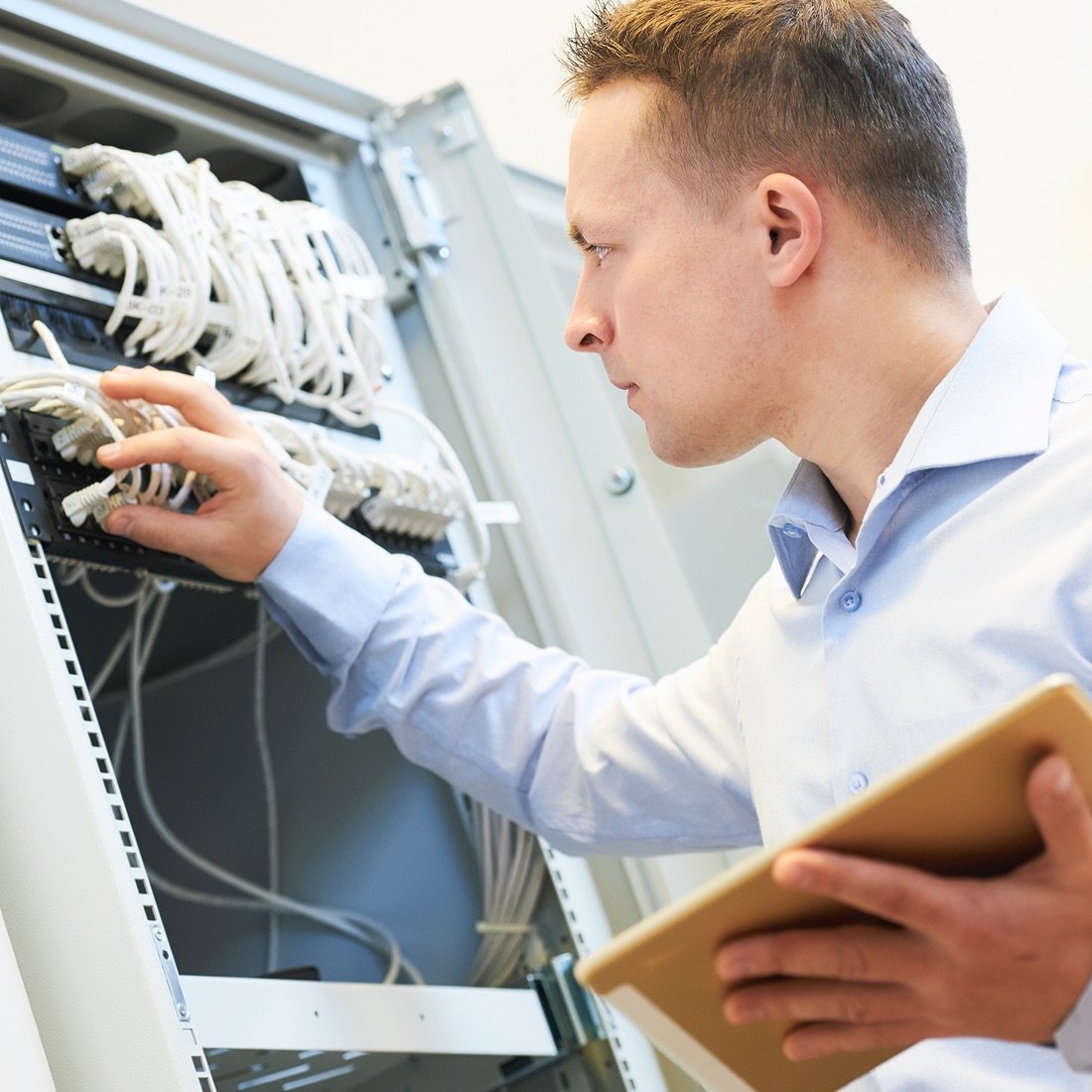 Person updating electrical equipment.