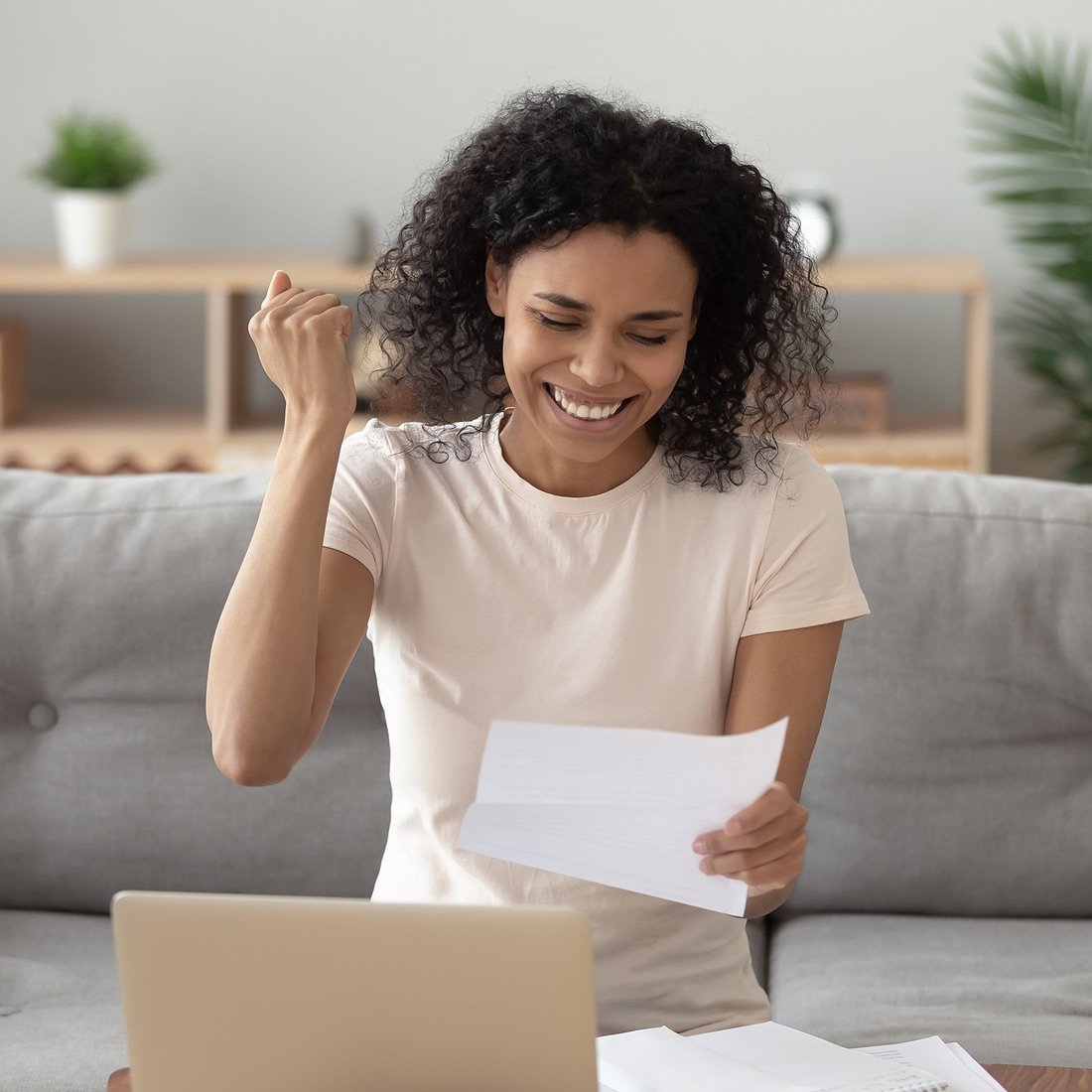 woman happy laptop paper