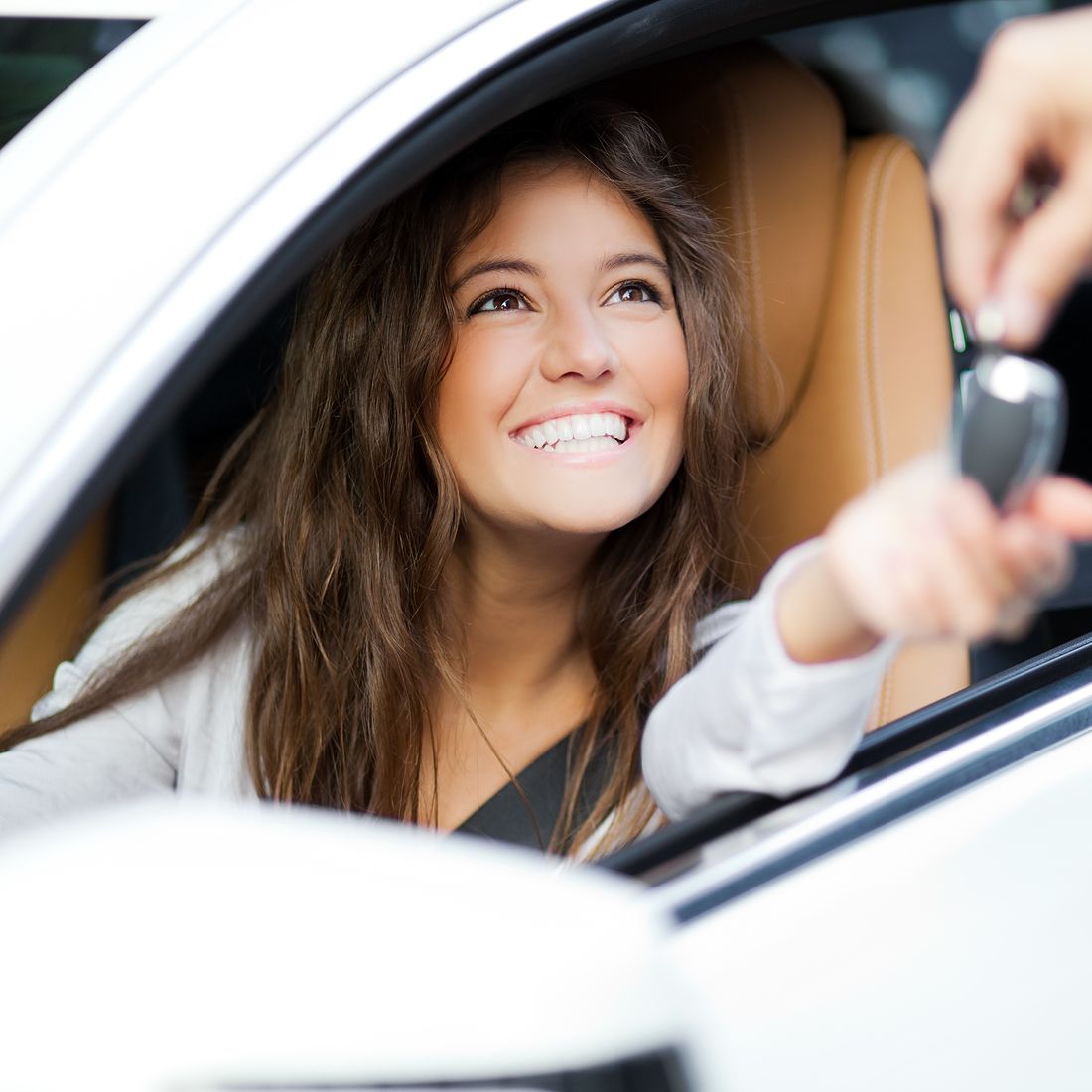 woman-receiving-keys-of-her-new-car-from-dealer-1100x1100