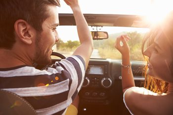 Couple laughing and driving