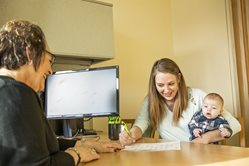 Woman happily signing form