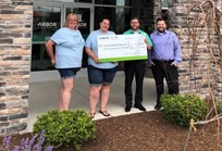 Our Caring Committee poses with staff from Unleashed Love Pet Rescue for a check presentation.