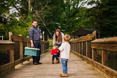 A family fishing off a bridge.